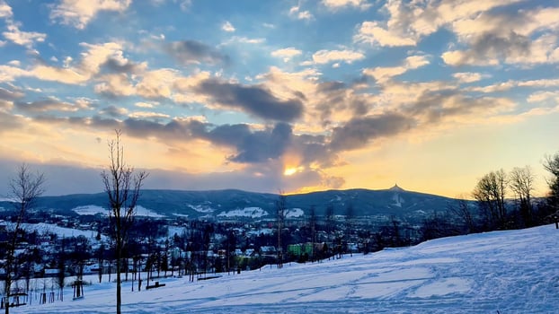 A Beautiful Winter Sunset painting the sky over a serene Snowy Landscape, truly captivating photo