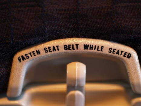 Fasten Seat Belt Message On Back Of Airplane Seat Tray Holder photo