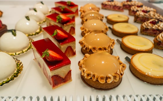 Colorful assortment of gourmet desserts displayed in a bakery showcasing delicious treats photo