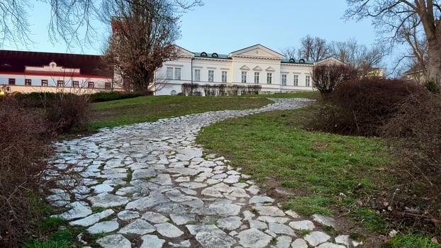 A Beautiful Pathway Leading to an Elegant and Historically Significant Building in Nature photo
