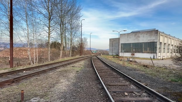 An abandoned railway and industrial site shows historys remnants and natures reclamation photo