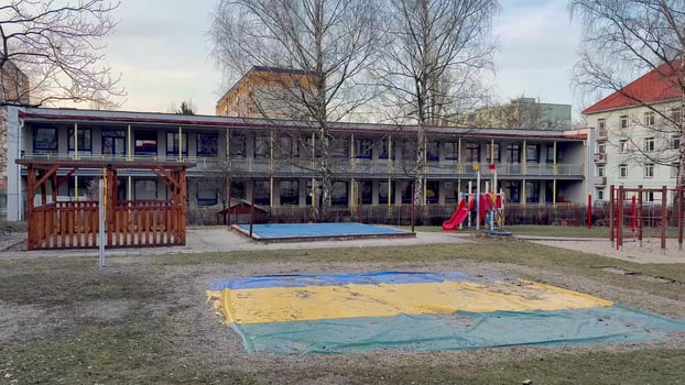 Playground Area Located in Close Proximity to a School Building for Various Activities photo