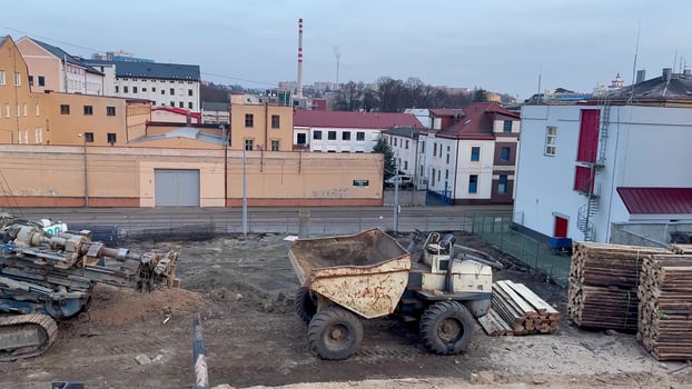 A construction site bustling with heavy machinery and numerous buildings is in progress photo