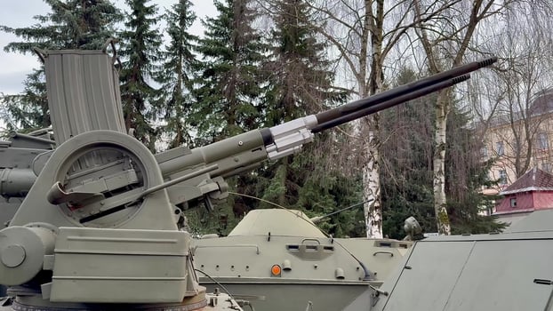Military Armament Detail A Heavy Artillery Gun Mounted on a Tank for Added Combat Efficiency photo