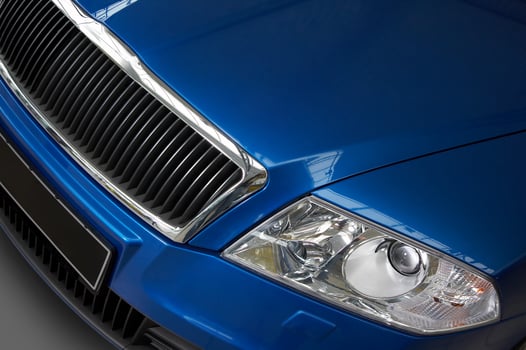 headlight and grate of radiator on a dark blue car photo