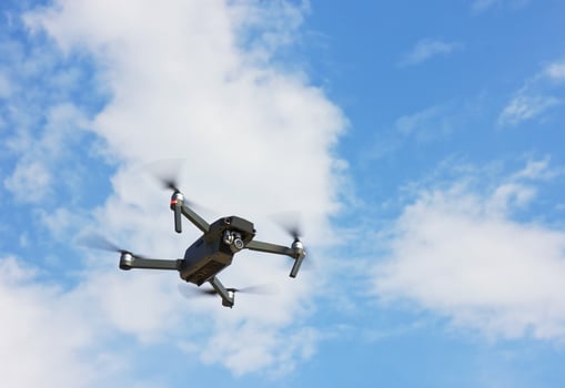 Flying Drone in a blue sky photo