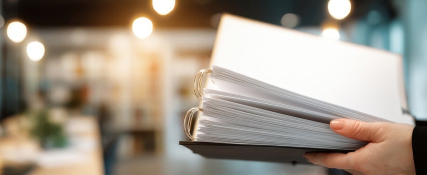 The professional binder being held in a modern office setting. photo