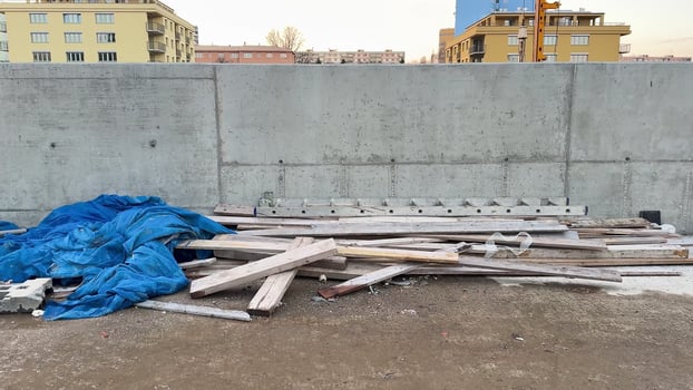 A construction site filled with various debris and covered with a blue tarpaulin for protection photo