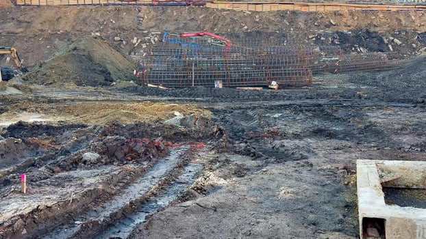 A bustling Construction Site that features ongoing Excavation and laying of Foundations photo