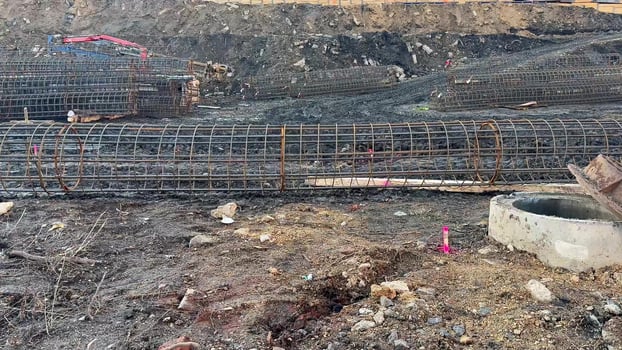 Construction Site Featuring Steel Reinforcement Bars Along with Foundations for Structures photo