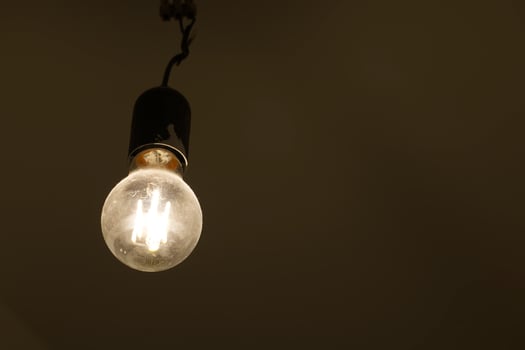 Illuminated LED Light Bulb in Dim Room photo