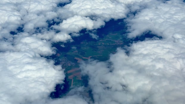 A breathtaking aerial view showcasing a stunning landscape covered in beautiful clouds photo
