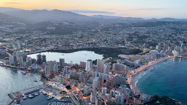 A breathtaking aerial view showcasing the stunning Acapulco coastline during a beautiful sunset photo