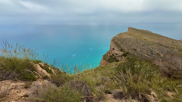 Enjoy the breathtaking Scenic Coastal Views complemented by Lush Greenery beneath Cloudy Skies photo