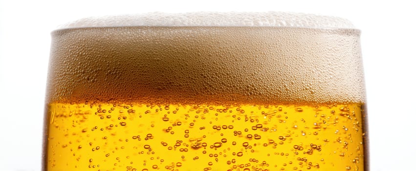 The frothy glass of beer showcasing refreshing golden liquid and bubbles. photo