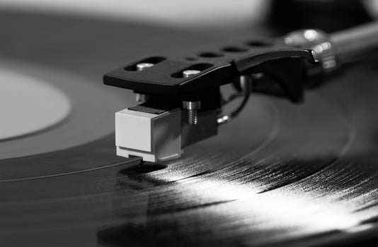 Record player playing vinyl on a white photo