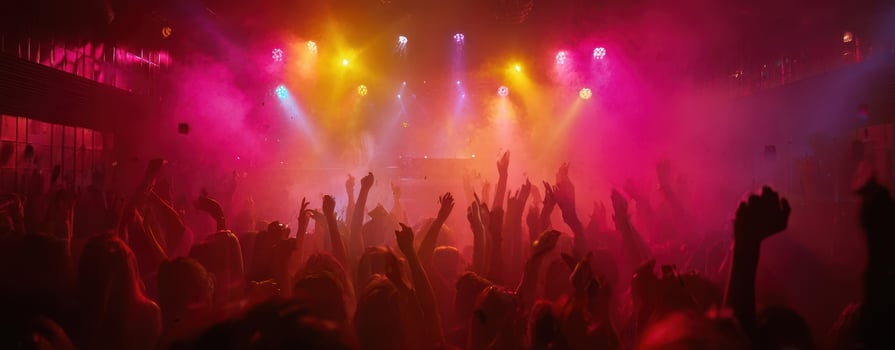The vibrant atmosphere of a lively concert with enthusiastic crowd and colorful lights photo