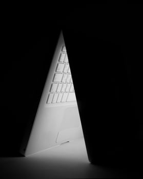 White laptop on dark photo