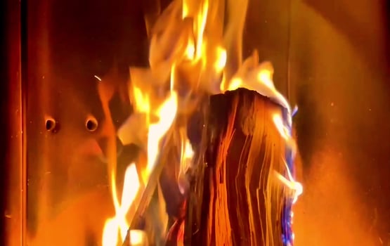 The Soft and Vibrant Flames of Firewood Burning Elegantly in a Cozy Fireplace Setting photo