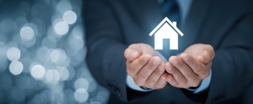 The Hands Holding a House Symbol Representing Real Estate Investment Opportunities photo