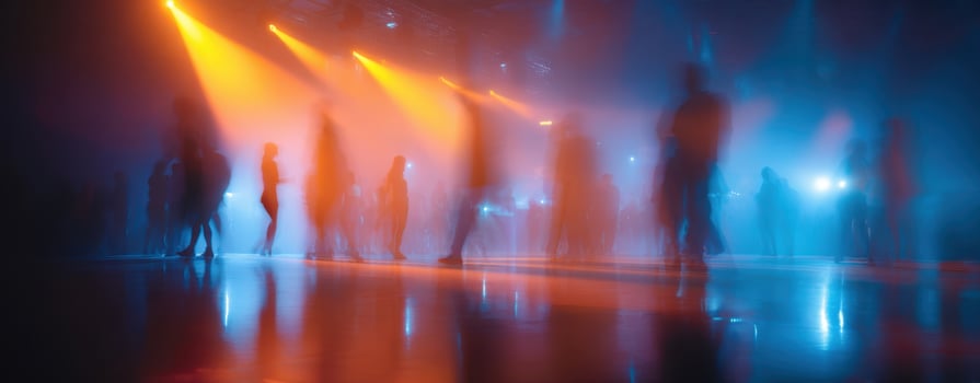 The vibrant dance scene illuminated by colorful lights and energetic silhouettes. photo