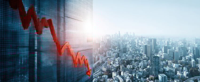 The downward trend depicted on a financial building against a city skyline. photo
