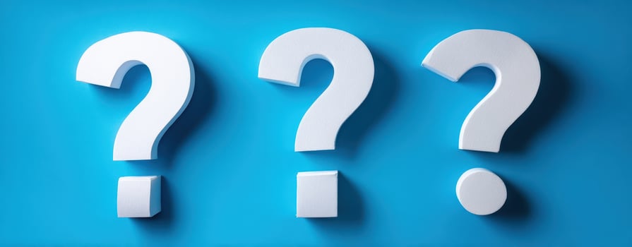 The question marks representing inquiry and curiosity against a blue background photo