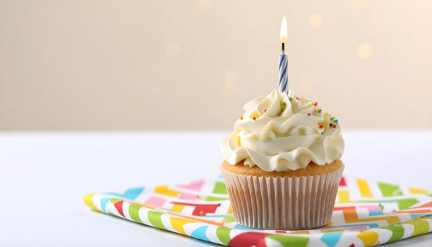 A cupcake with a single candle on top photo