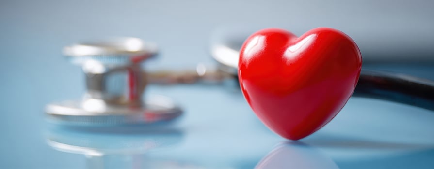 The heart symbolizing health and wellness alongside a medical stethoscope. photo