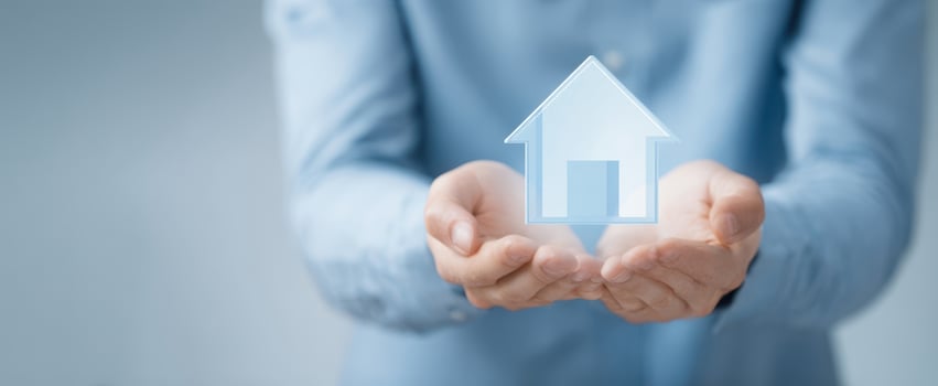 The hands holding a digital representation of a house for real estate investment. photo