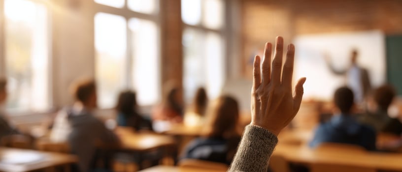 The raised hand of a student eager to participate in class discussion. photo