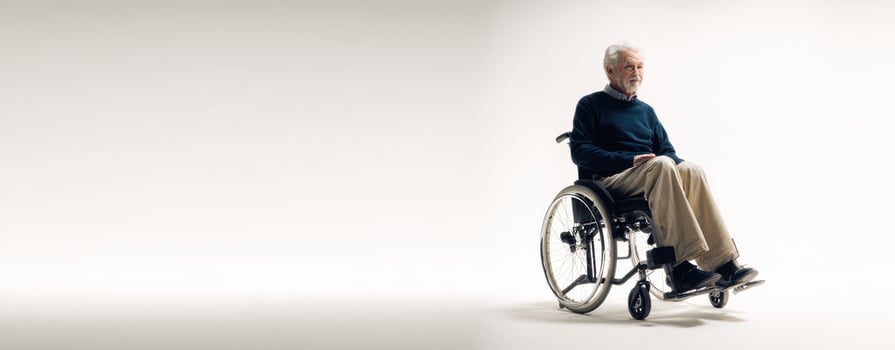 The reflective elderly man seated in a wheelchair in a minimalistic setting. photo