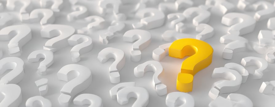 The yellow question mark stands out among a sea of white question marks. photo
