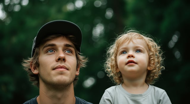 A man and a child looking up at the sky photo