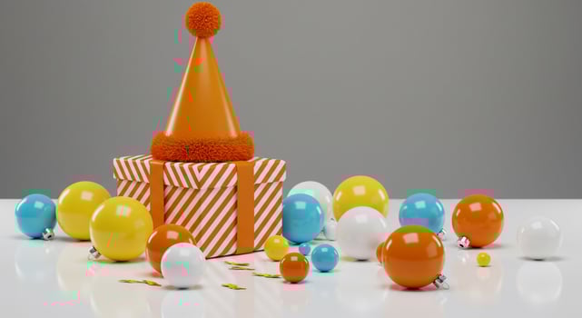 Festive Orange Party Hat, Striped Gift Box, and Bright Ornaments for Celebration photo