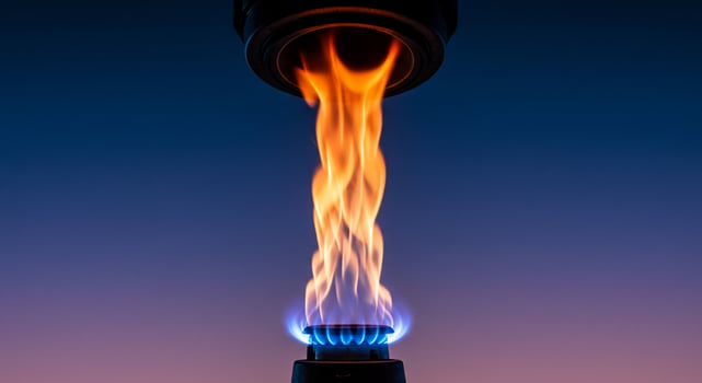 Vibrant Blue and Orange Gas Flame Burning Against a Dark Gradient Background photo