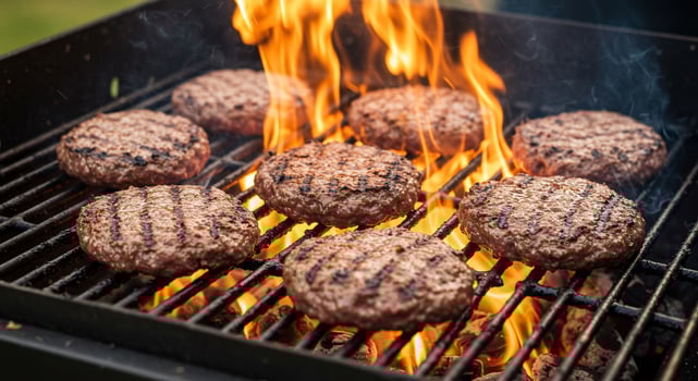 Juicy Beef Burger Patties Sizzling on a Hot Grill with Flames photo