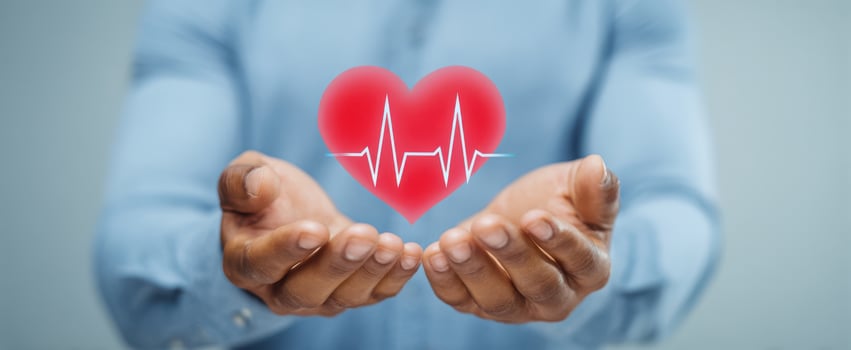 The heart held in hands symbolizes love and health awareness. photo
