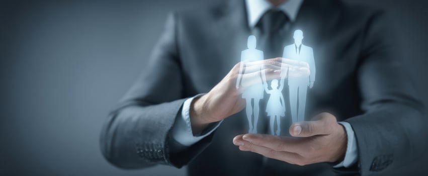 The businessman protecting a holographic family representation in his hands. photo
