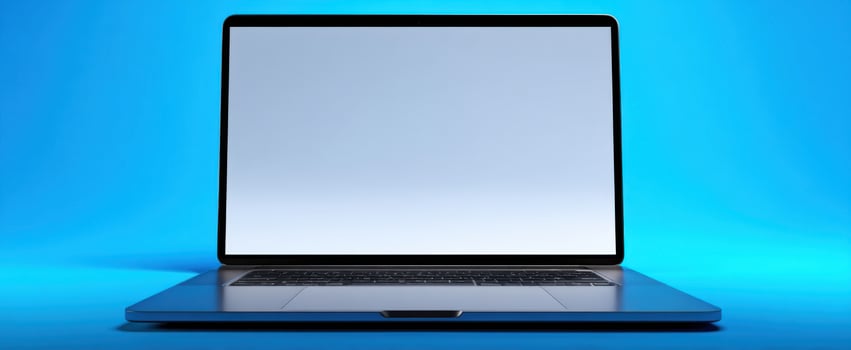 The sleek laptop with a blank screen against a vibrant blue background photo