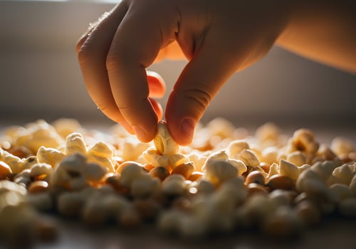 Hand picking popcorn kernels photo