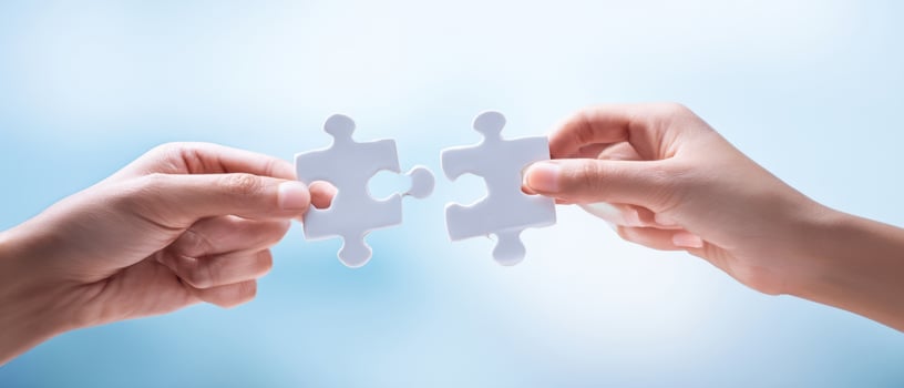The hands connecting puzzle pieces in a collaborative teamwork effort. photo