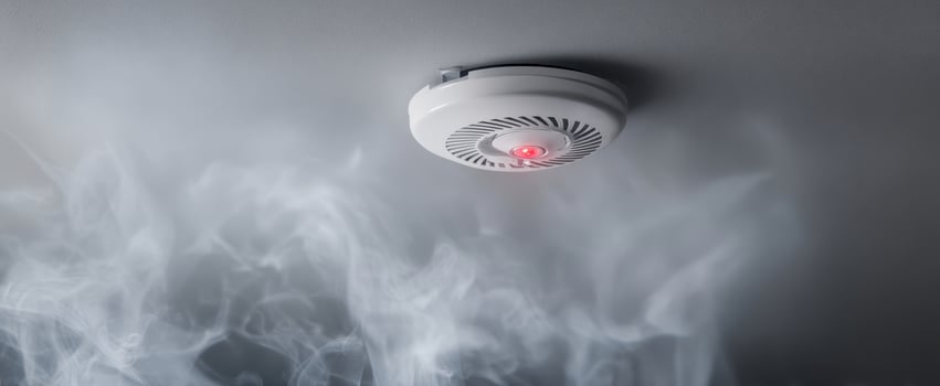 The Smoke Detector Alarming in a Home Environment with Surrounding Smoke photo