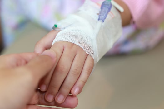 A person holding a hand with a bandage on it photo