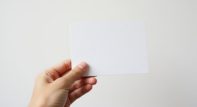 Blank Card Held in Hand on White Background photo