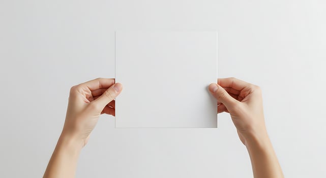Square Paper Sheet Held by Two Hands photo