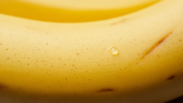 A close up of a banana with a drop of water on it photo