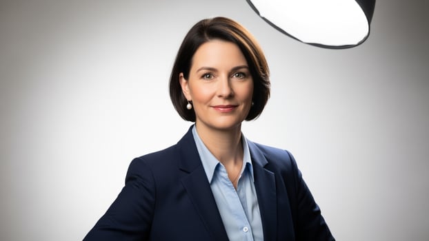 A woman in a business suit posing for a photo