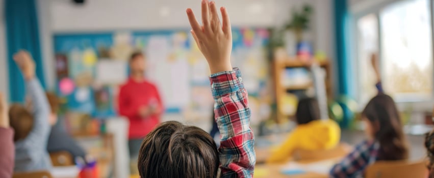 The engaged student raising hand in a vibrant classroom setting. photo