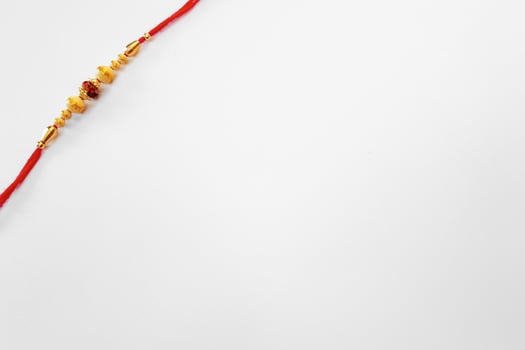 Elegant Detailed Rakhi Bracelet with Beads and Red Thread for Celebration.,. photo